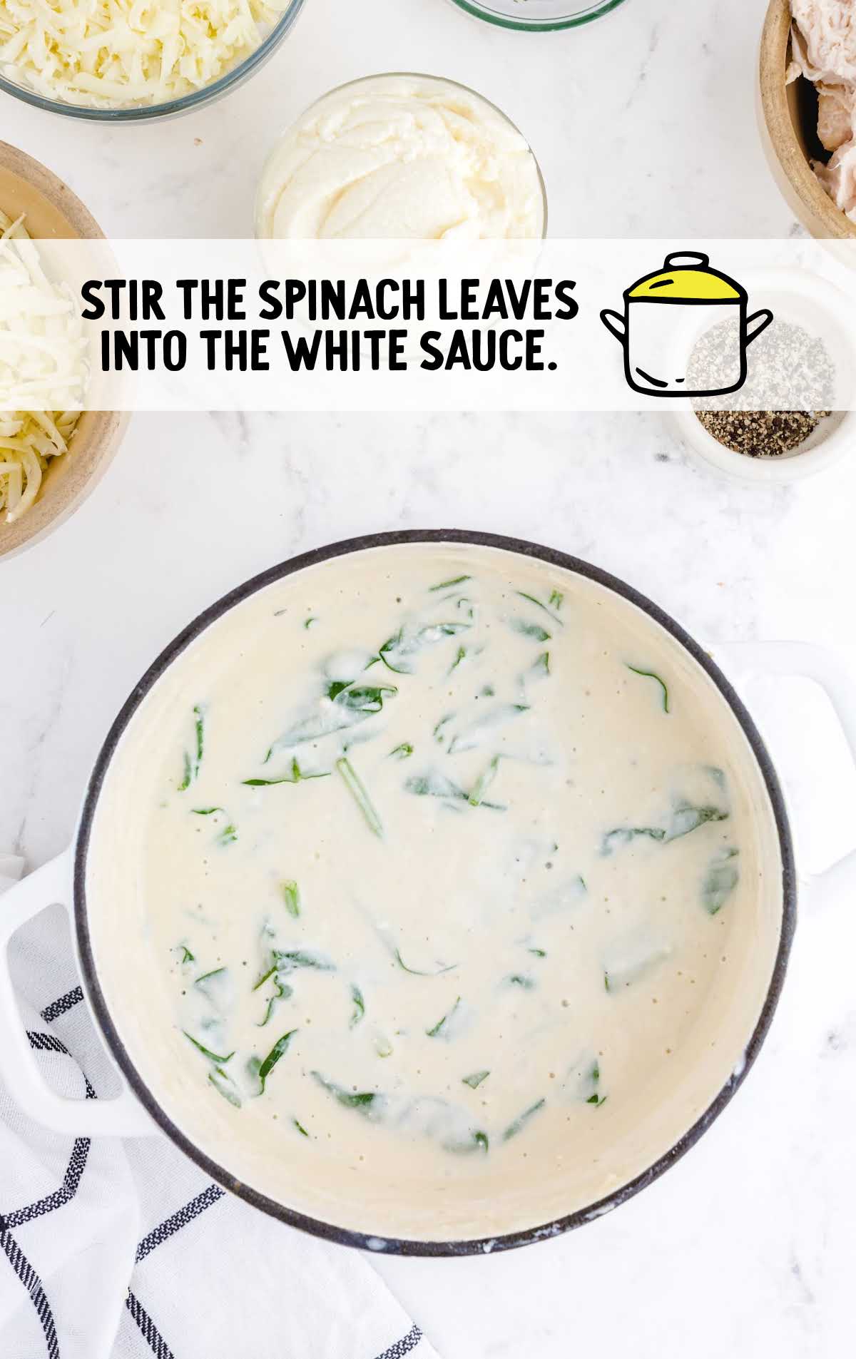 spinach leaves stirred into the white sauce