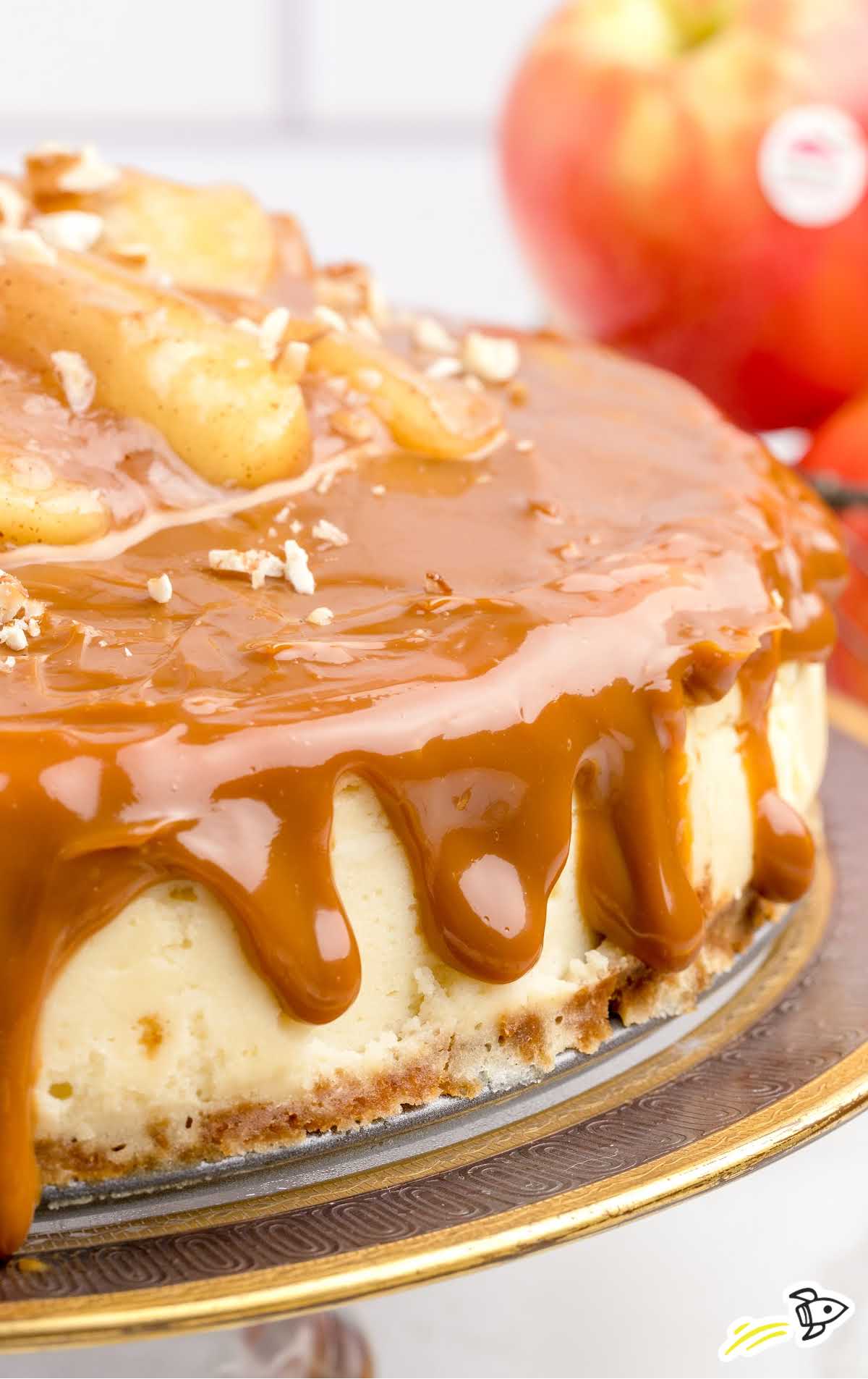 close up shot of Caramel Apple Cheesecake on a cake stand
