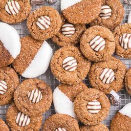 close up overhead shot of gingerbread kiss cookies on a cooling rack
