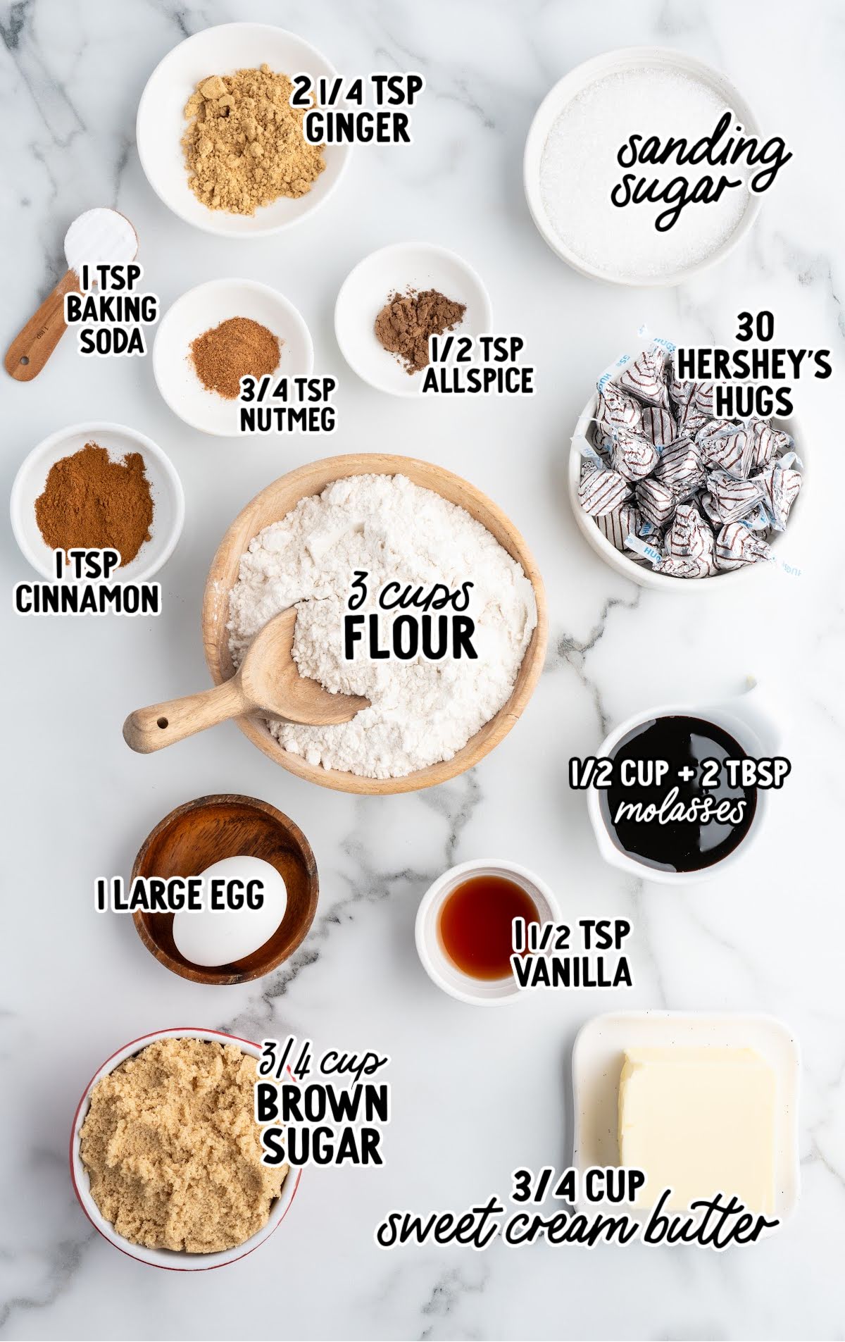 Labeled ingredients laid out for gingerbread kiss cookies, including spices, flour, molasses, brown sugar, and Hershey’s Hugs.