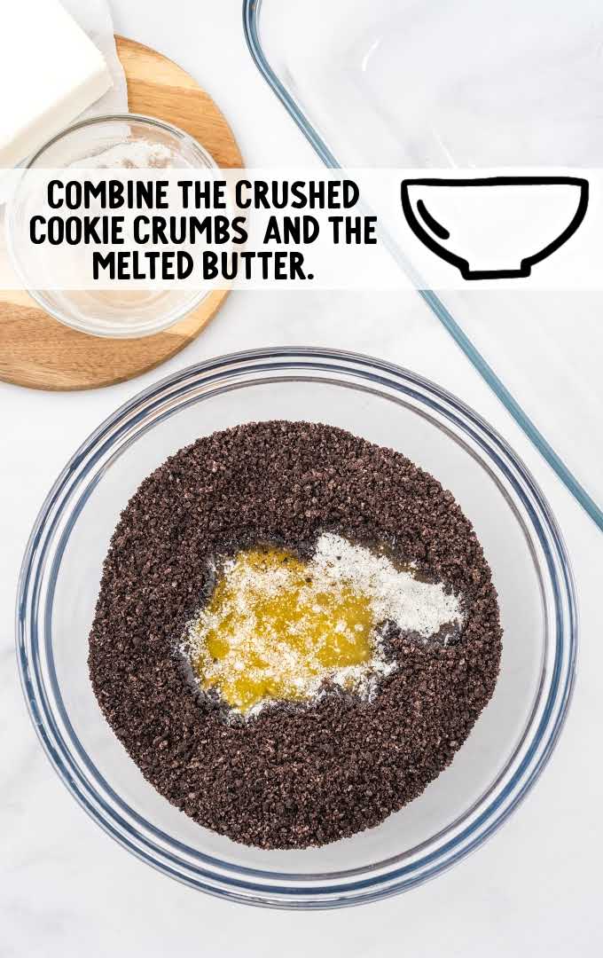 crushed cookies crumbs and butter combined in a bowl