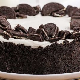 close up shot of a no bake oreo cheesecake topped with crushed Oreos on a plate