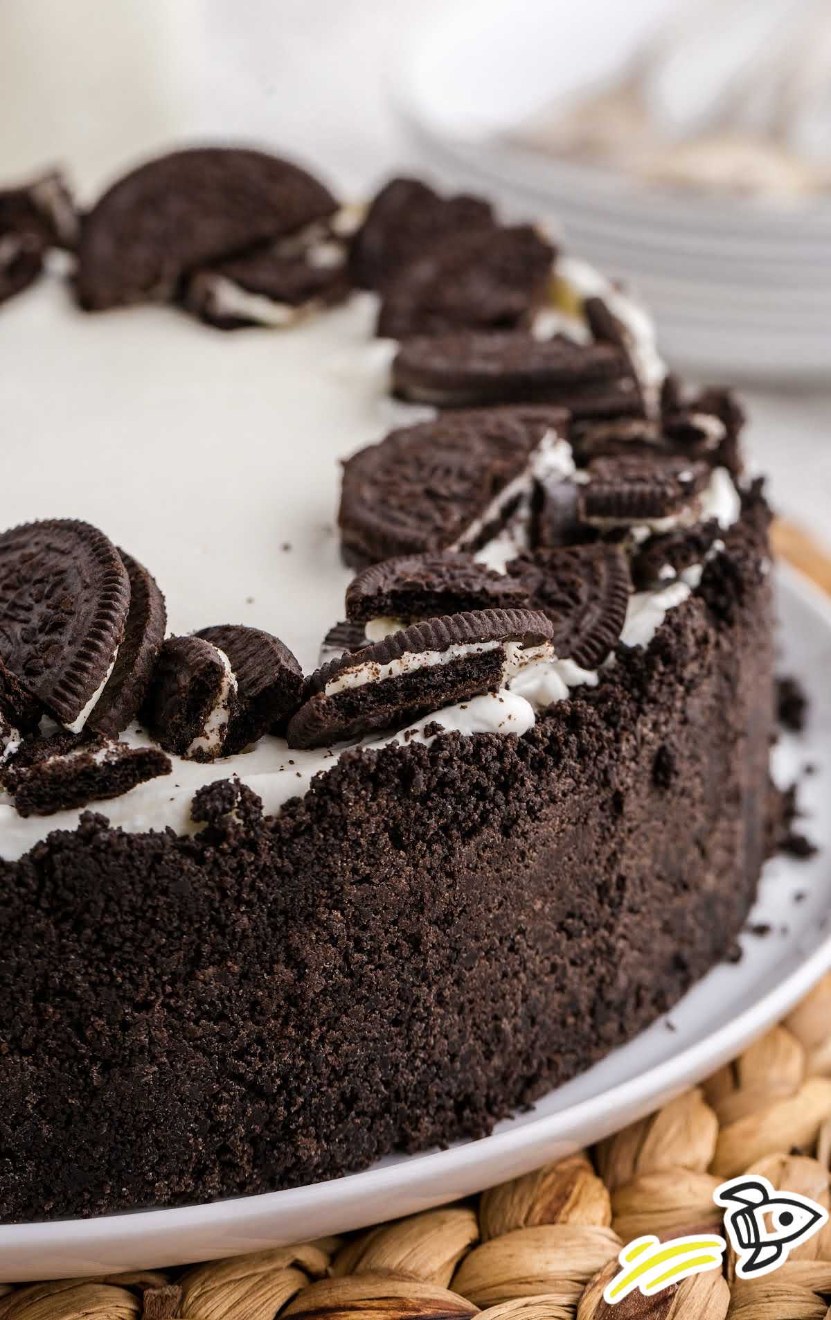 a close up shot of No Bake Oreo Cheesecake on a cake stand