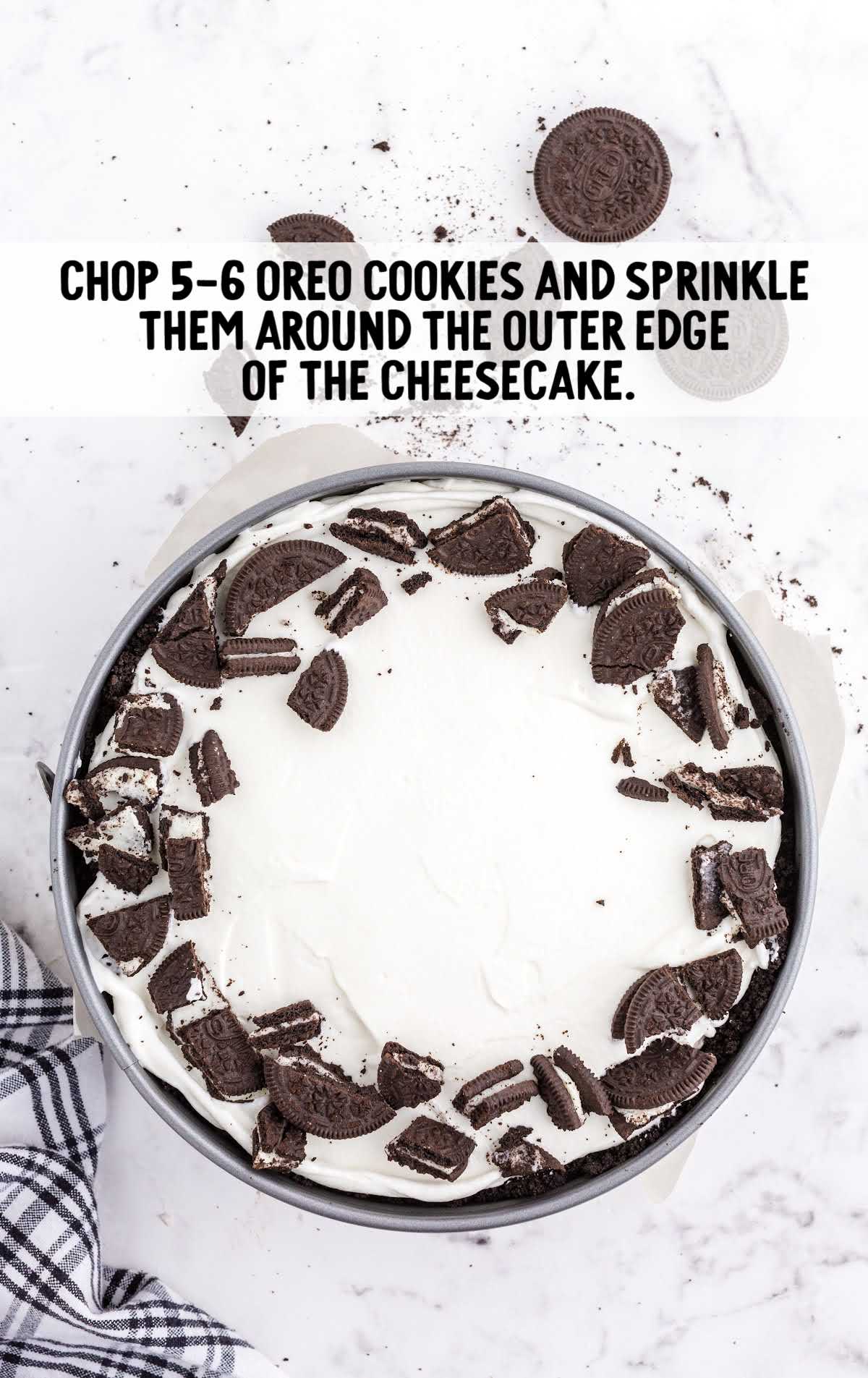 chopped up oreos sprinkled around the cheesecake