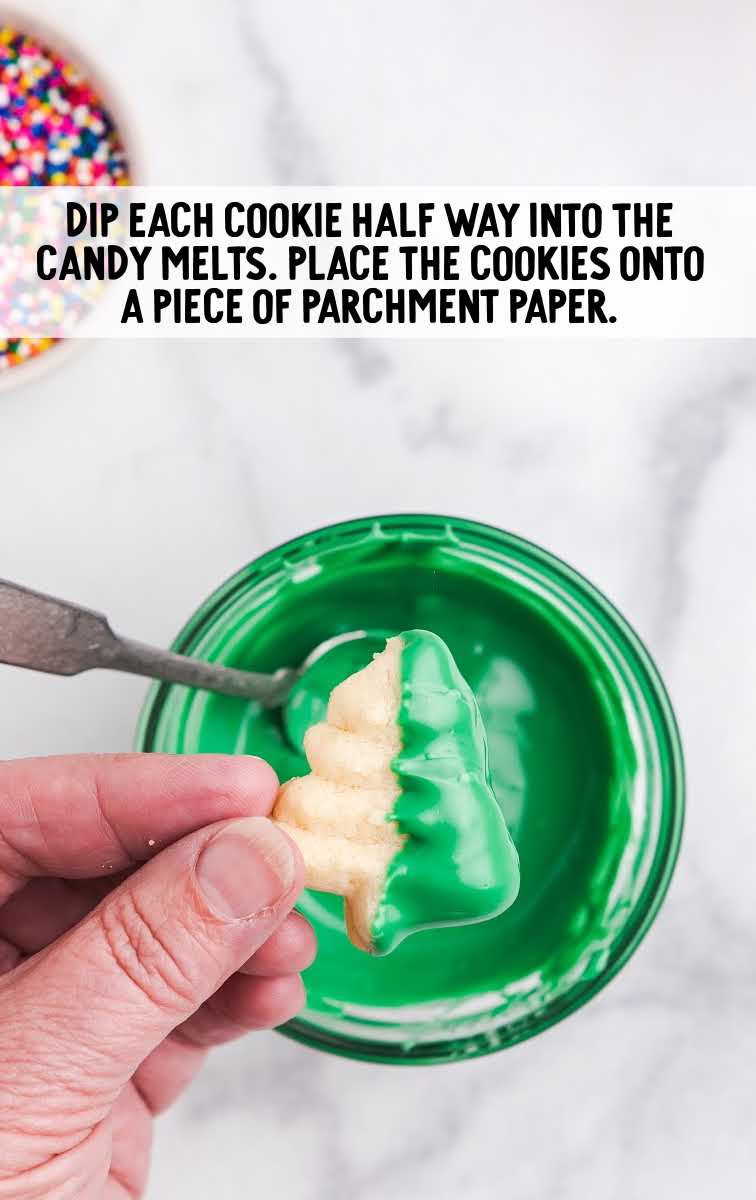 cookie being dipped into a bowl of candy melts