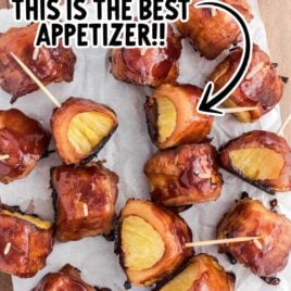 close up overhead shot of Bacon-Wrapped Pineapple on a wooden board