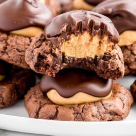 close up shot of a bunch of Buckeye Brownie Cookies on a plate