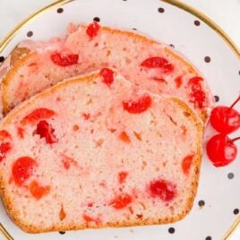 close up overhead shot of slices of Cherry Bread with cherries on a plate