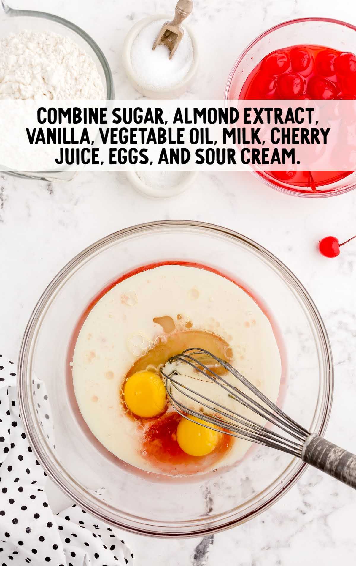 sugar, almond extract, vanilla, vegetable oil, milk, cherry juice, eggs, and sour cream whisked together in a bowl