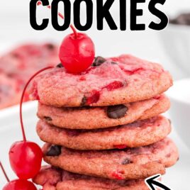 close up shot of Cherry Chocolate Chip Cookies stacked on top of each other with a bunch of cherries and chocolate chips
