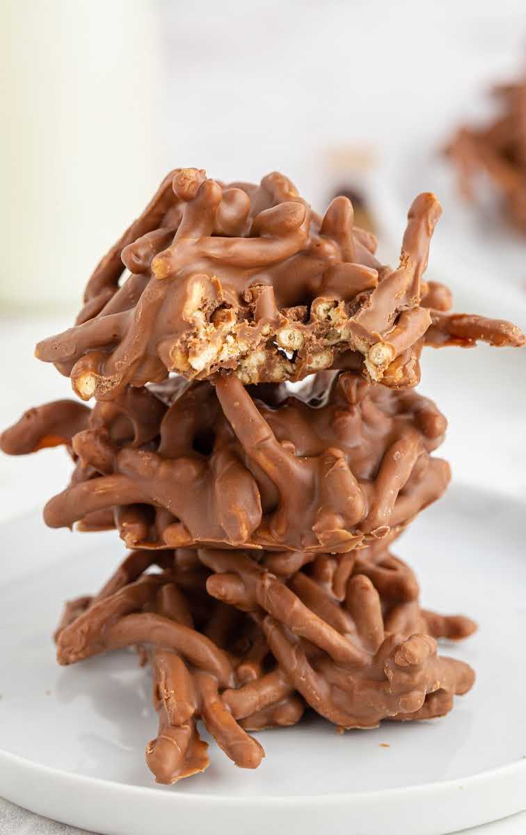 close up shot of a plate of Chocolate Haystacks stacked on top of each other