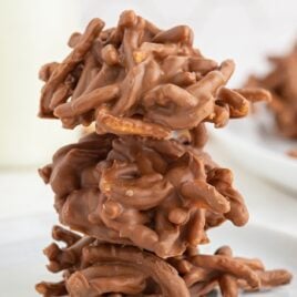 close up shot of Chocolate Haystacks stacked on top of each other on a plate