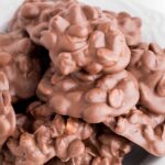 close up shot of Chocolate Peanut Clusters piled on top of each other