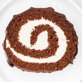 close up overhead shot of a slice of Chocolate Swiss Roll on a plate