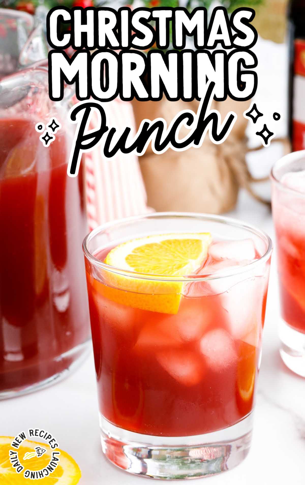 a glass of punch garnished with a orange slice