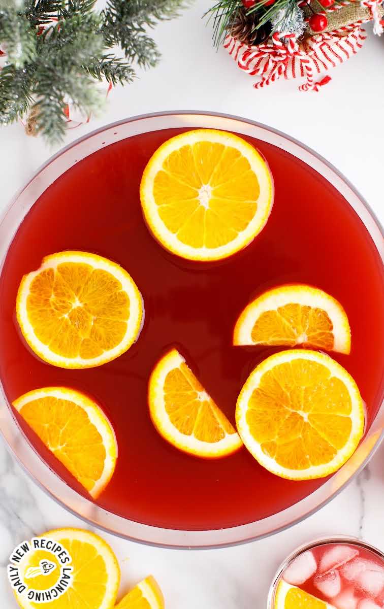 close up overhead shot of a punch bowl of Christmas Morning Punch garnished with orange slices