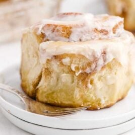 close up shot of a plate of Cinnabon Cinnamon Rolls with a fork