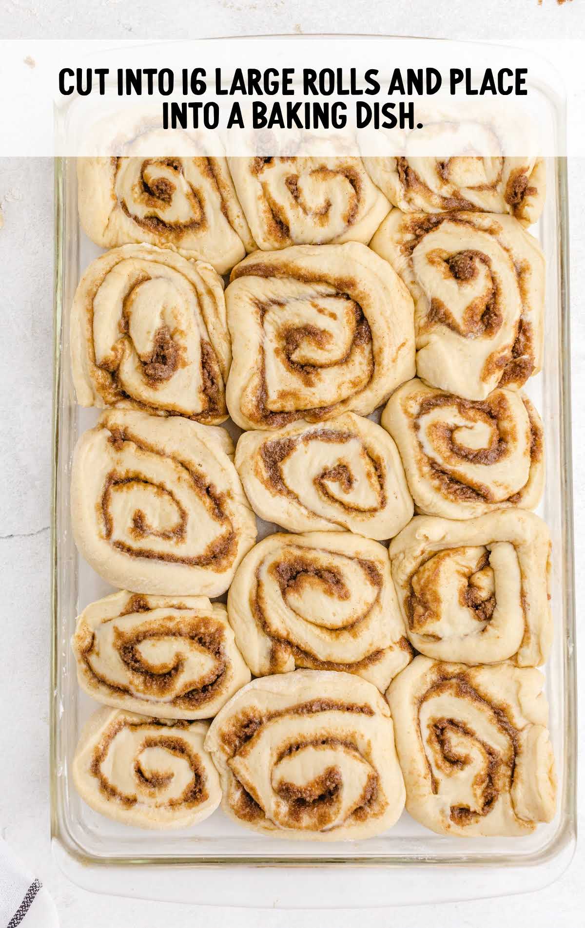 Cinnabon Cinnamon Rolls process shot of large rolls cut and and placed into a baking dish