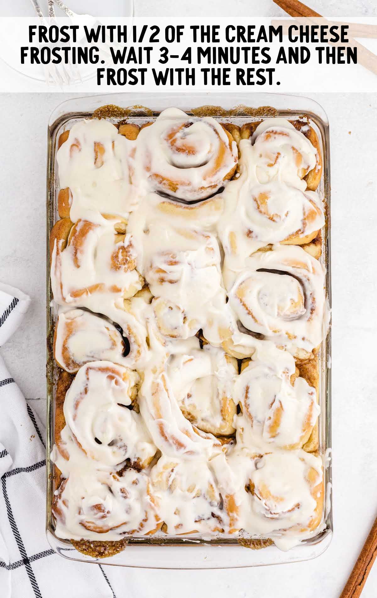 Cinnabon Cinnamon Rolls process shot of rolls frosted with the cream cheese frosting