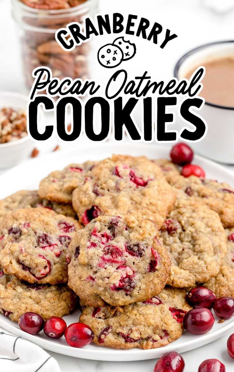 close up shot of a plate piled with Cranberry Pecan Oatmeal Cookies and garnished with cranberries