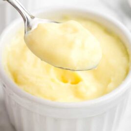 close up shot of a bowl of Custard with a spoonful of custard