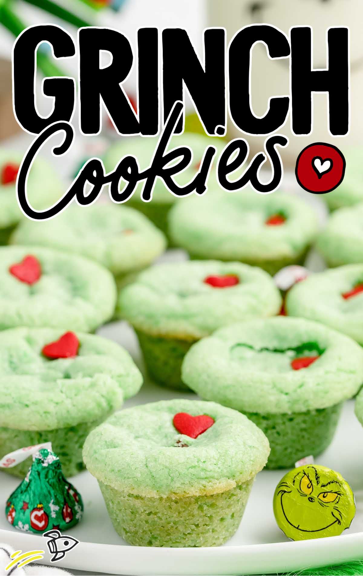 close up shot of Grinch Stuffed Cookies topped with a heart candy sprinkle on a plate