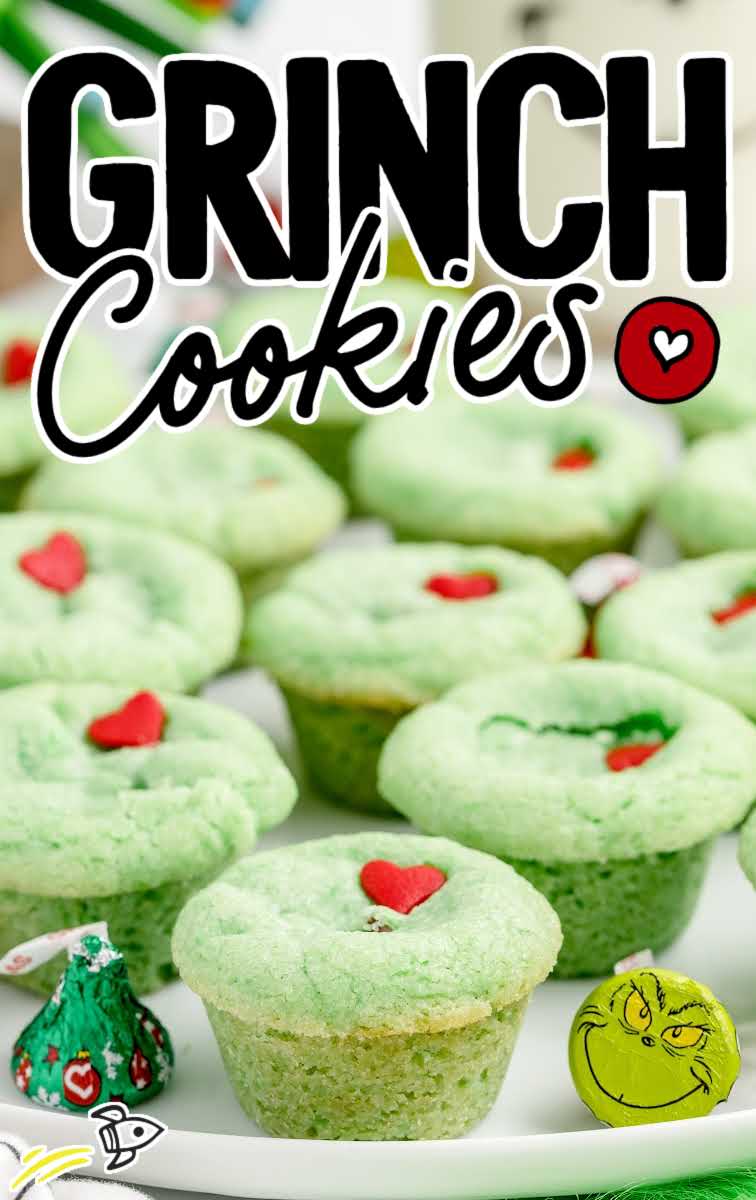 close up shot of Grinch Stuffed Cookies topped with a heart candy sprinkle on a plate