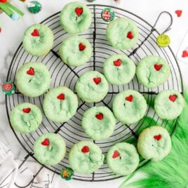 a cooling rack of Grinch Stuffed Cookies