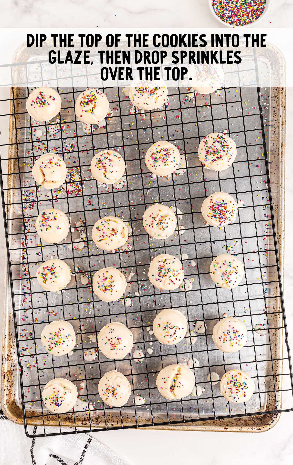 Italian Cookies process shot of the top of the cookies dipped in glaze and topped with sprinkles