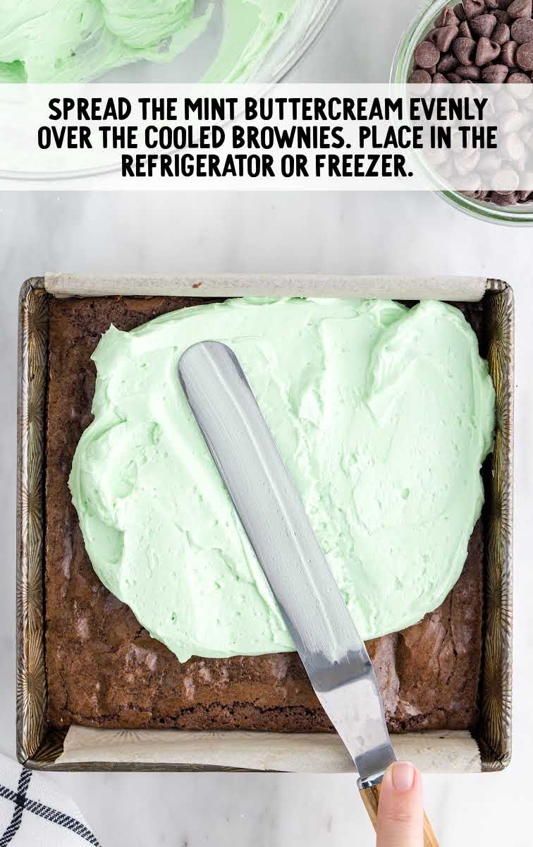 mint buttercream spread over the brownie