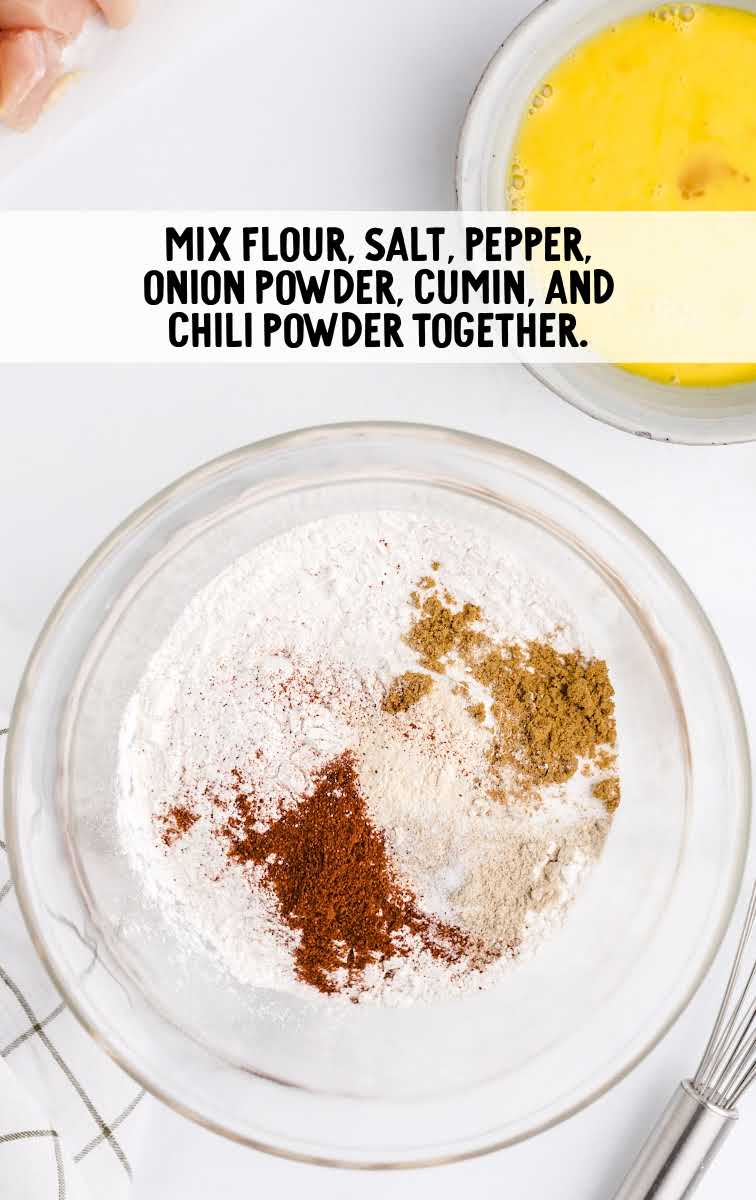 mix flour, salt, pepper, onion powder, cumin, and chili powder 
