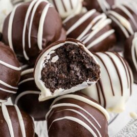 close up shot of a bunch of Oreo Balls with a bite taken out of one of them