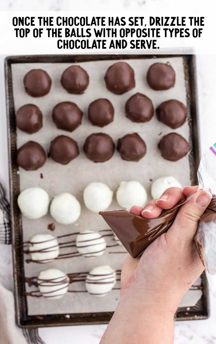 Oreo Balls process shot of white chocolate Oreo Balls being drizzled with chocolate and chocolate Oreo Balls being drizzled with white chocolate on a baking sheet