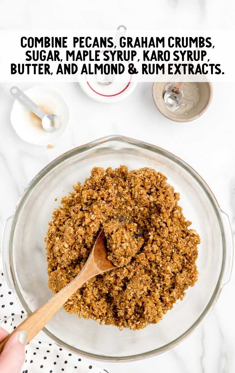 pecans, graham crumbs, sugar, maple syrup, karo syrup, butter, and almond and rum extract mixed together in a bowl