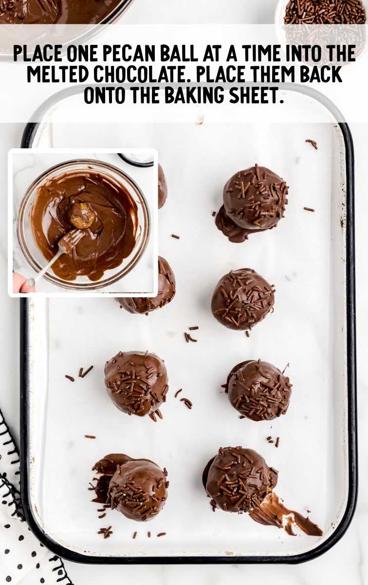 pecan balls dipped into melted chocolate and placed on a baking sheet