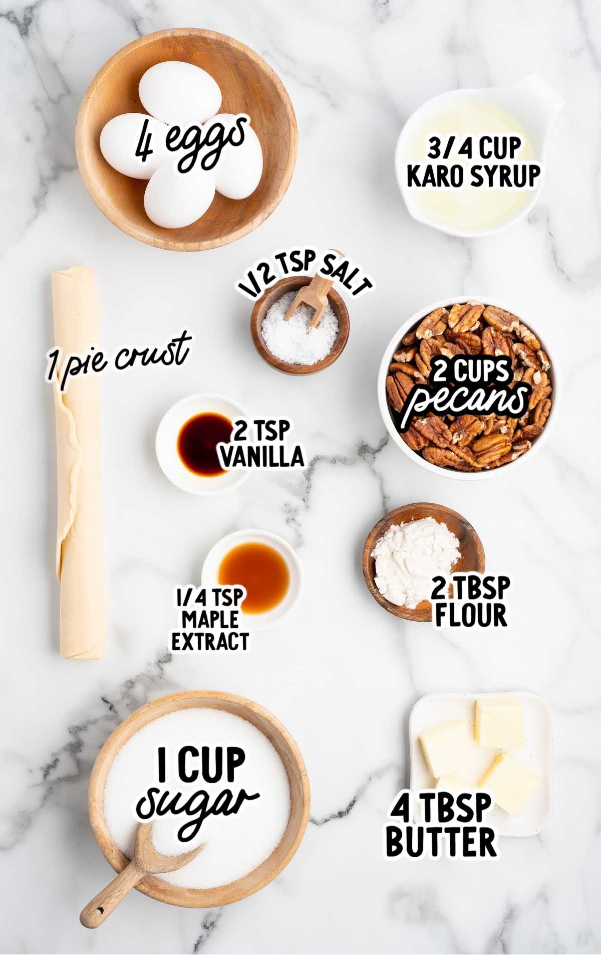 Labeled pecan pie ingredients laid out on a marble surface.