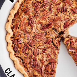 close up overhead shot of a Pecan Pie in a baking dish with a slice missing