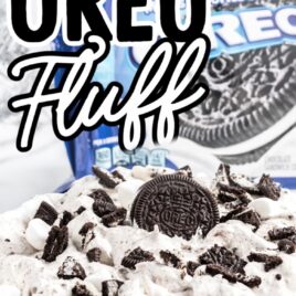 close up shot of a bowl of oreo fluff topped Oreos and mini marshmallows with a package of Oreos in the back
