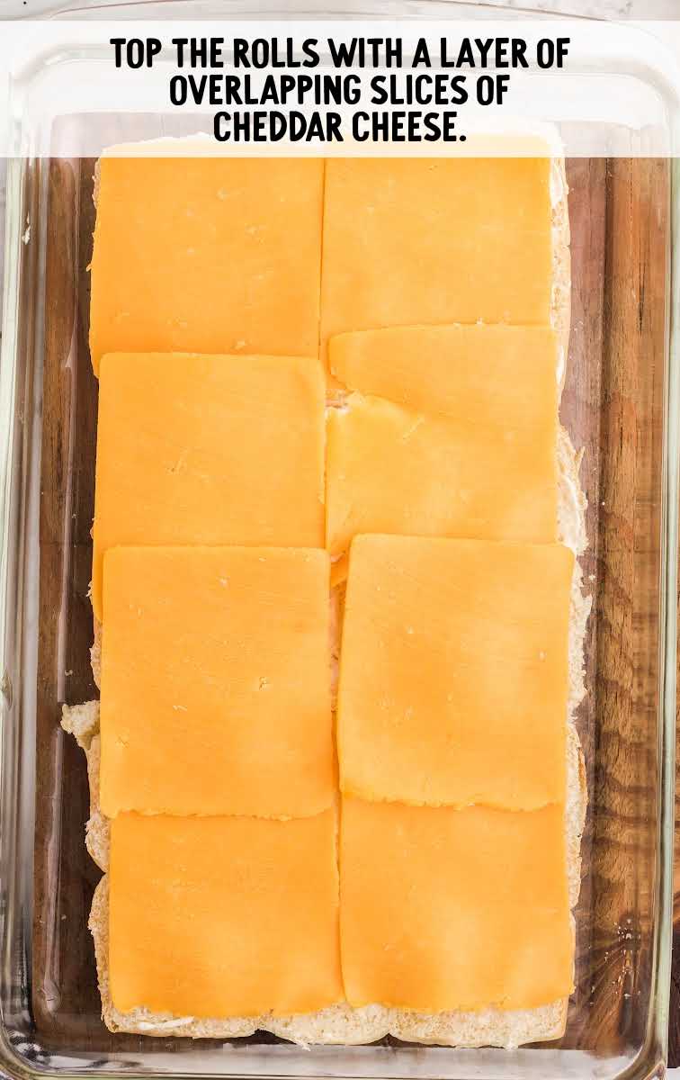 Roast Beef Sliders process shot of cheddar cheese placed on top of Hawaiian Rolls