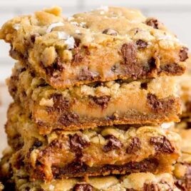 close up shot of Salted Caramel Chocolate Chip Cookie Bars stacked on top of each other