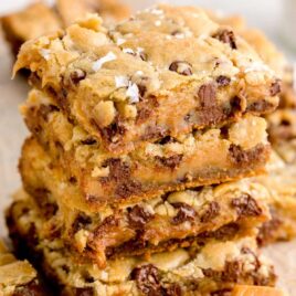 close up shot of Salted Caramel Chocolate Chip Cookie Bars stacked on top of each other