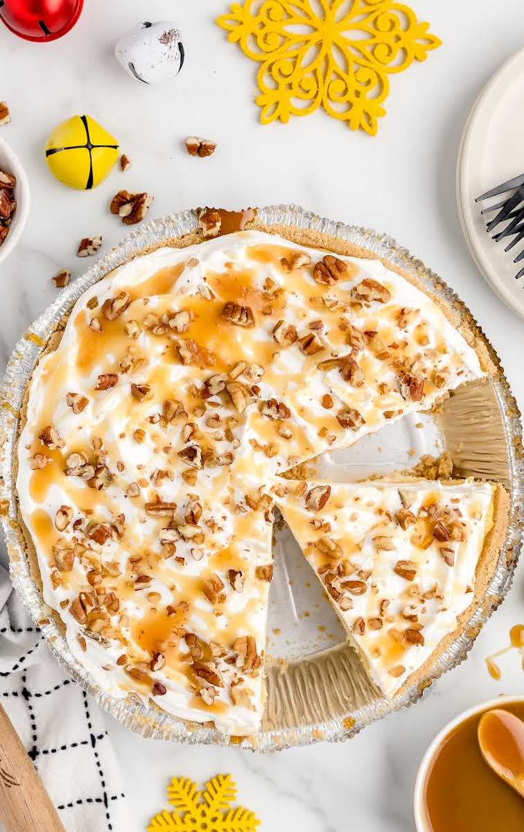 overhead shot of Salted Caramel No-Bake Pie garnished with crushed pecans and drizzled with caramel syrup