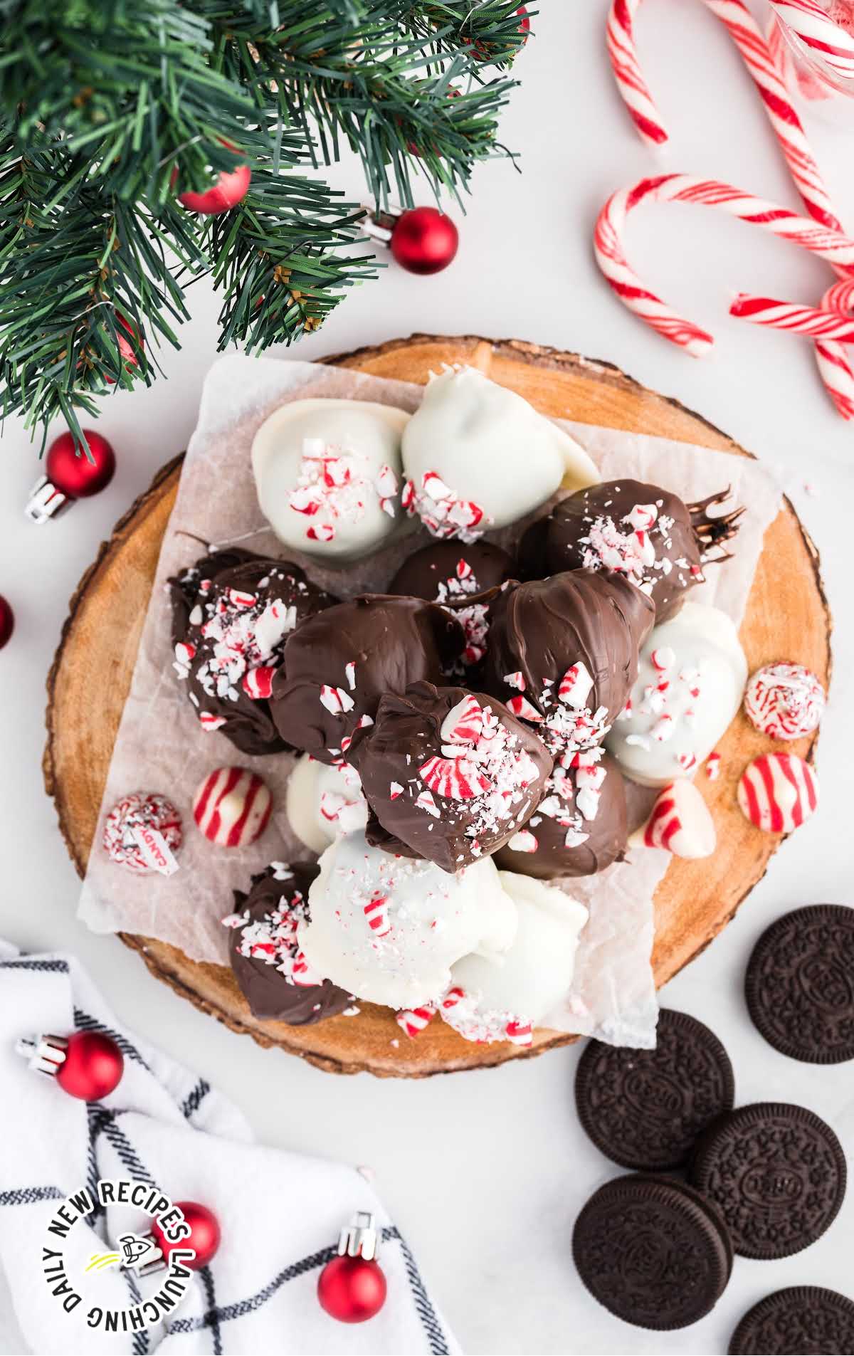 overhead shot of Surprise Inside Oreo Balls sprinkled with crushed peppermint on a wooden board