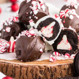 close up shot of Surprise Inside Oreo Balls sprinkled with crushed peppermint on a wooden board
