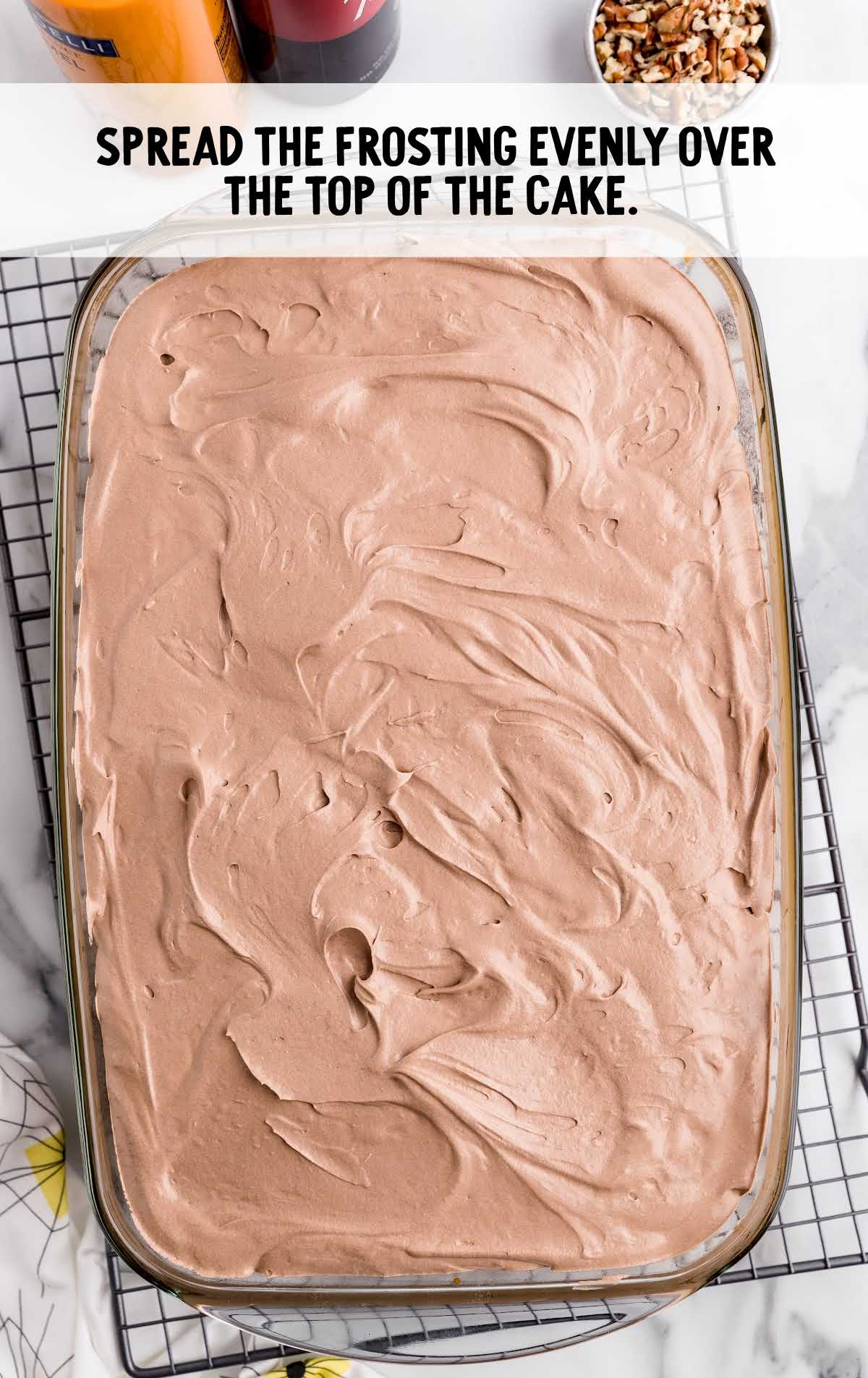 chocolate fudge frosting spread over the top of the cake