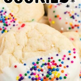 close up shot of cake mix cookies dipped in melted frosting and topped with sprinkles