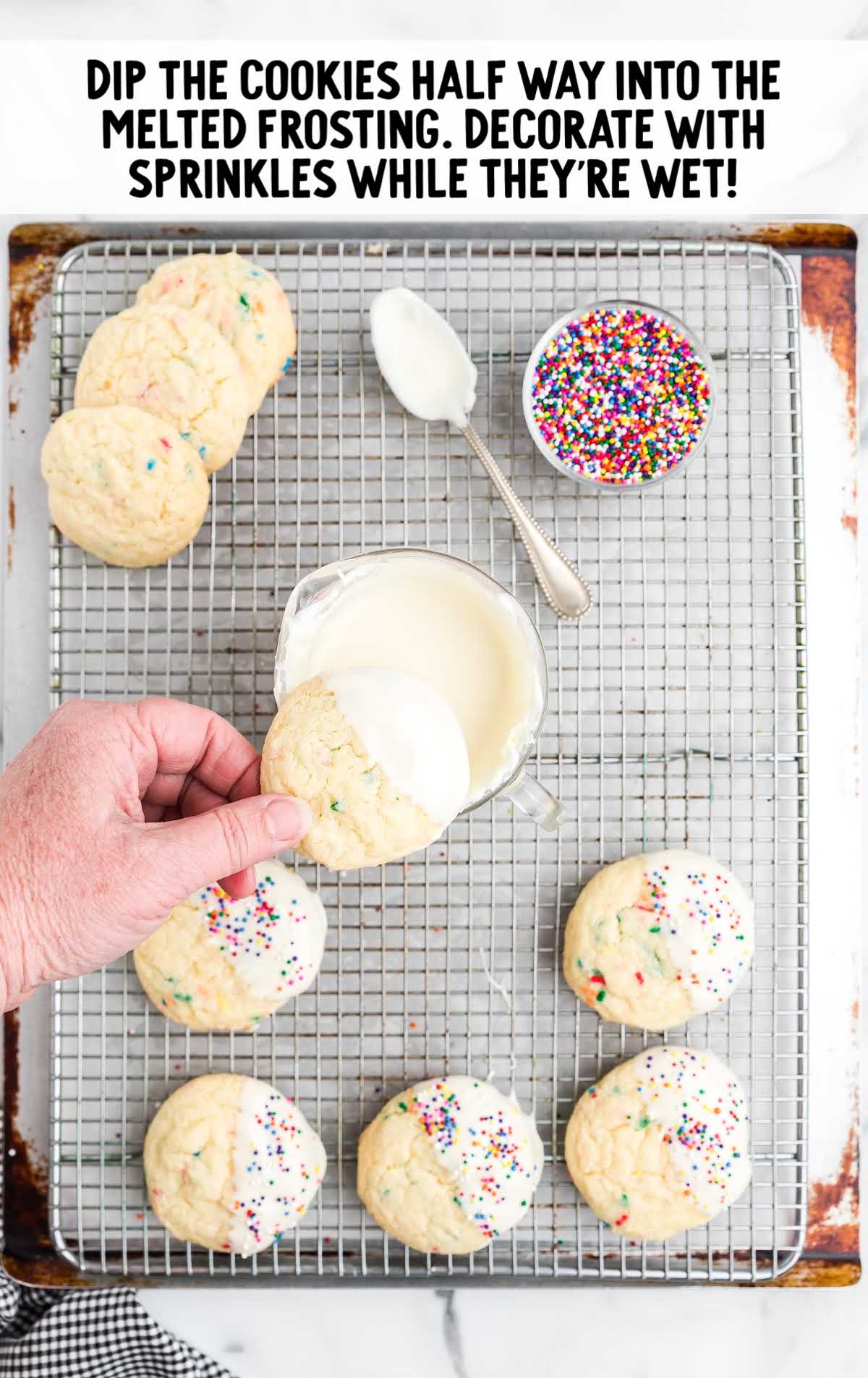 cookies dipped into melted frosting, topped with sprinkles, and placed on a cooking rack