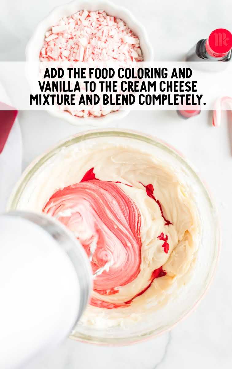 food coloring and vanilla added to the cream cheese mixture whisked together in a bowl