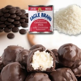 No bake coconut truffles with chocolate coating, sweetened condensed milk, and shredded coconut.