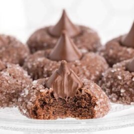 close up shot of a bunch of chocolate kiss cookies on a serving plate